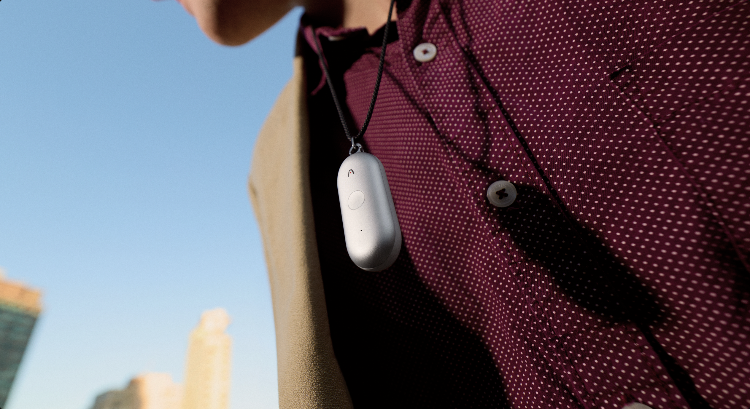 A professional wearing the Plaud NotePin S clipped to a shirt collar